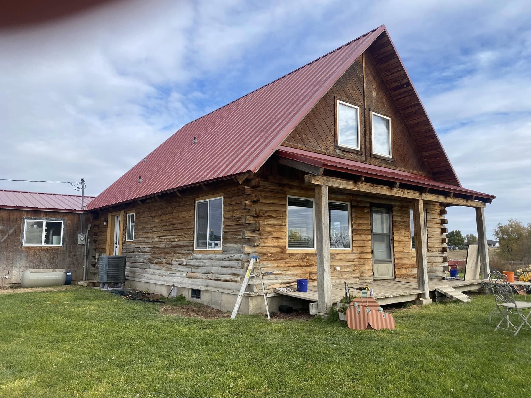 The log home before restoration — greyed and weathered