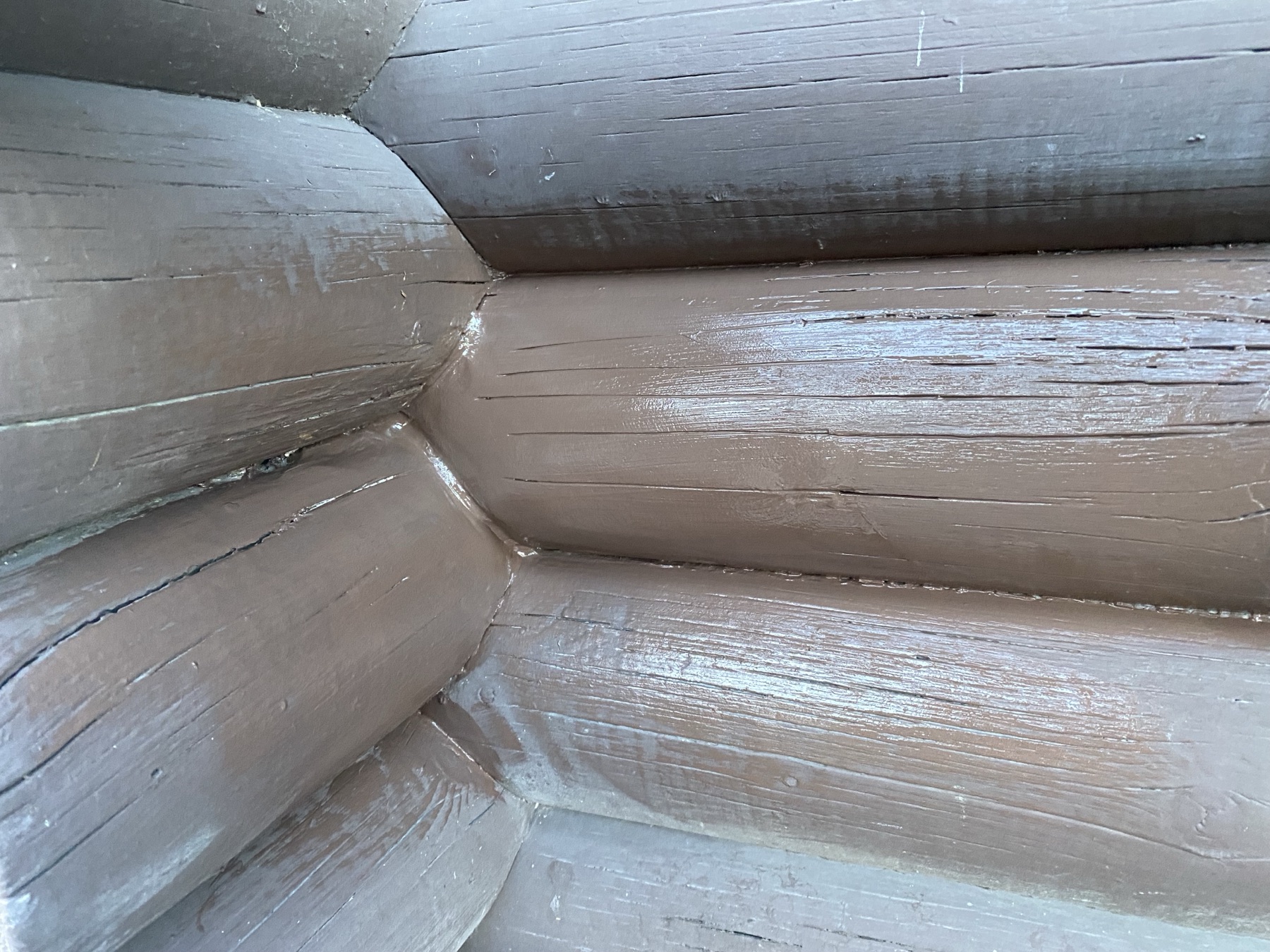 Freshly stained, hand-fit log corners