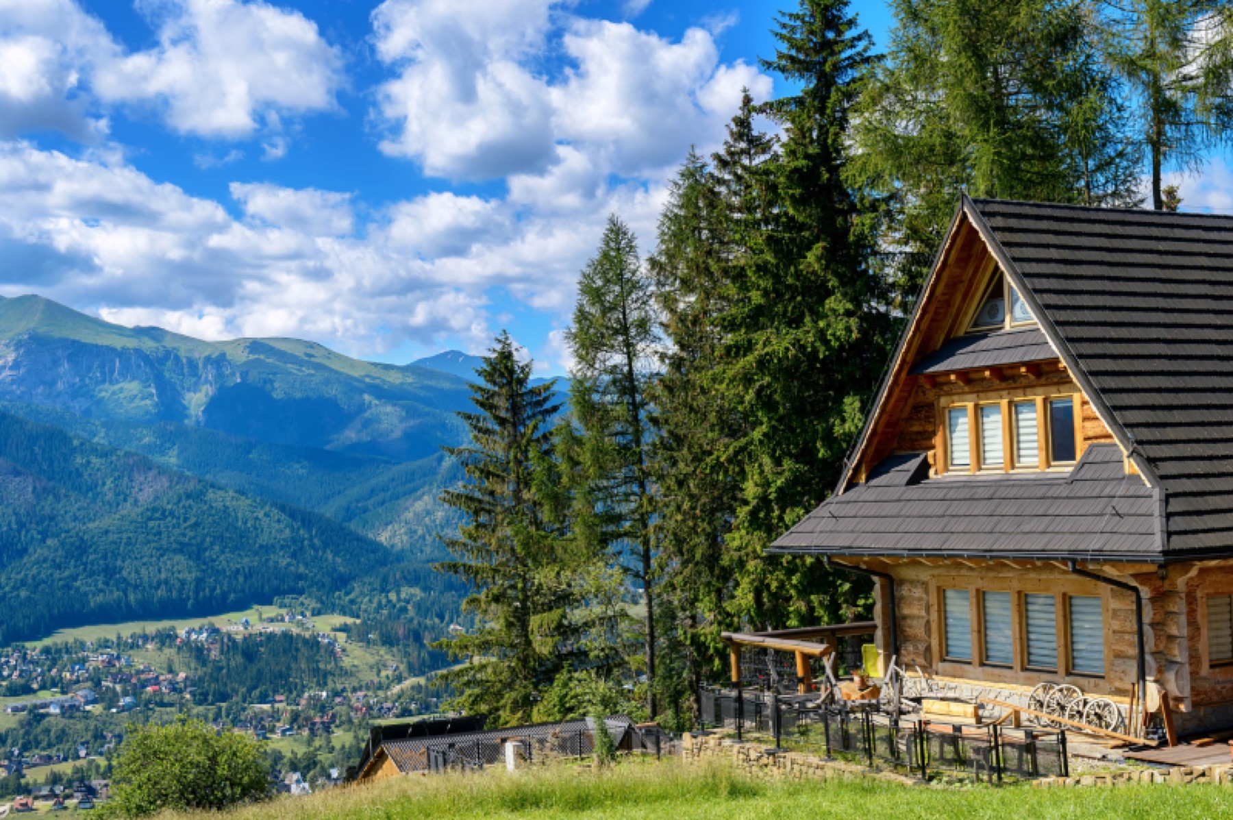 A log home restored by River to River, set against the mountains